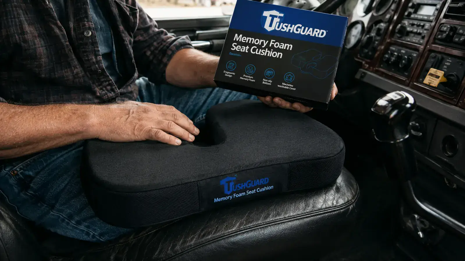 TushGuard memory foam seat cushion placed on the driver seat of a semi truck cab