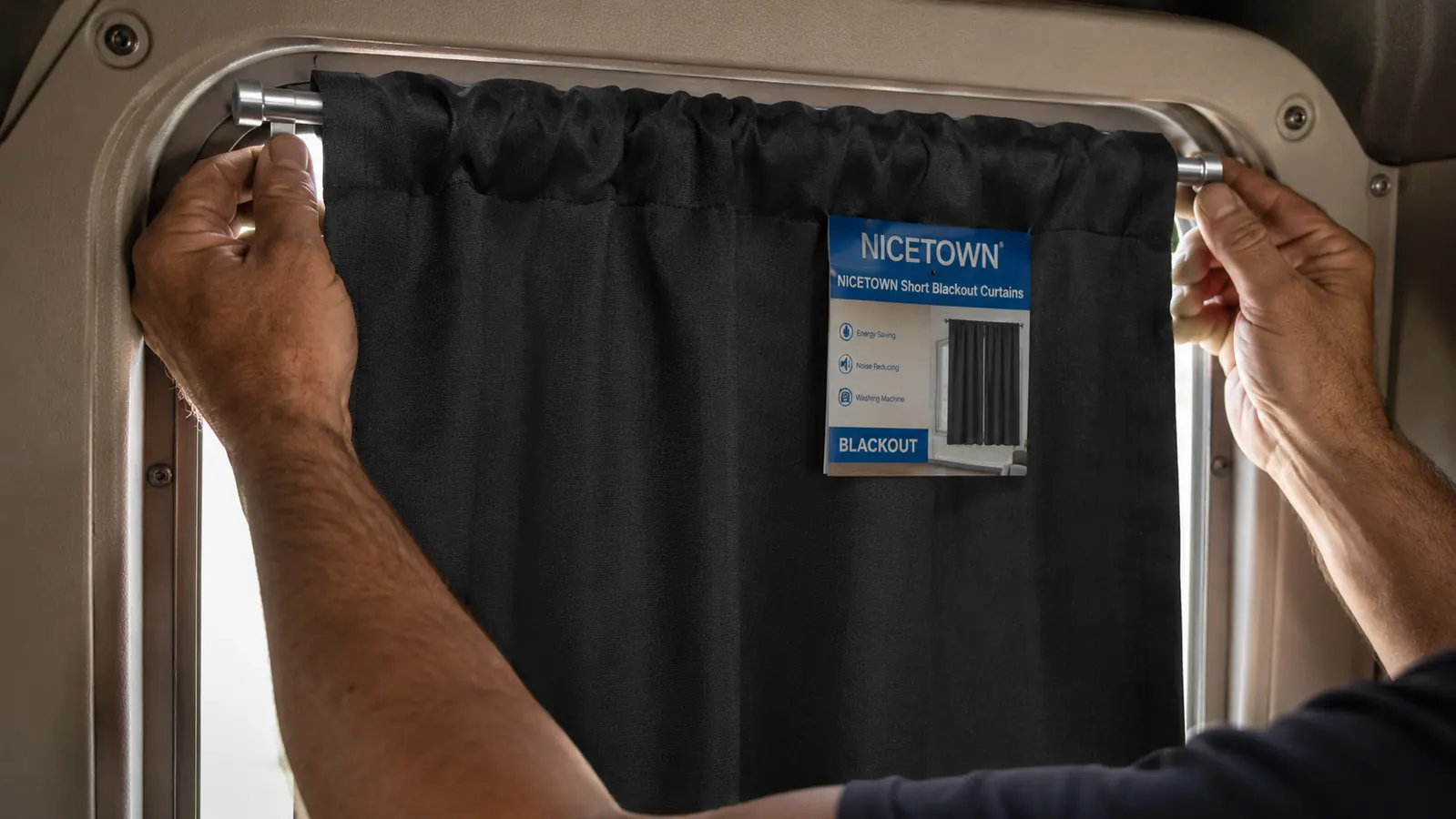 NICETOWN blackout curtain panels mounted on a tension rod inside a semi truck sleeper window
