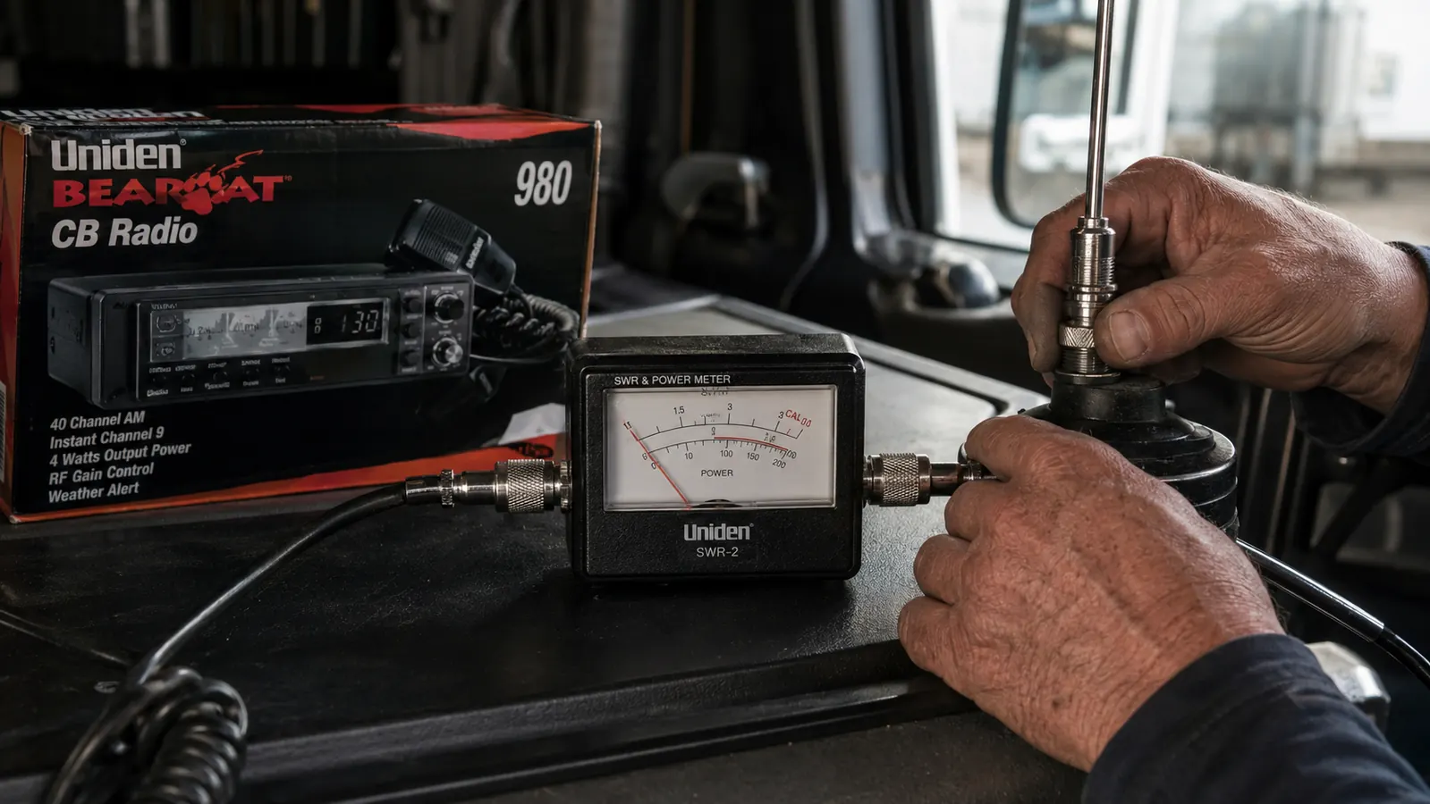 SWR meter connected between a CB radio and an antenna coax cable showing a low SWR reading