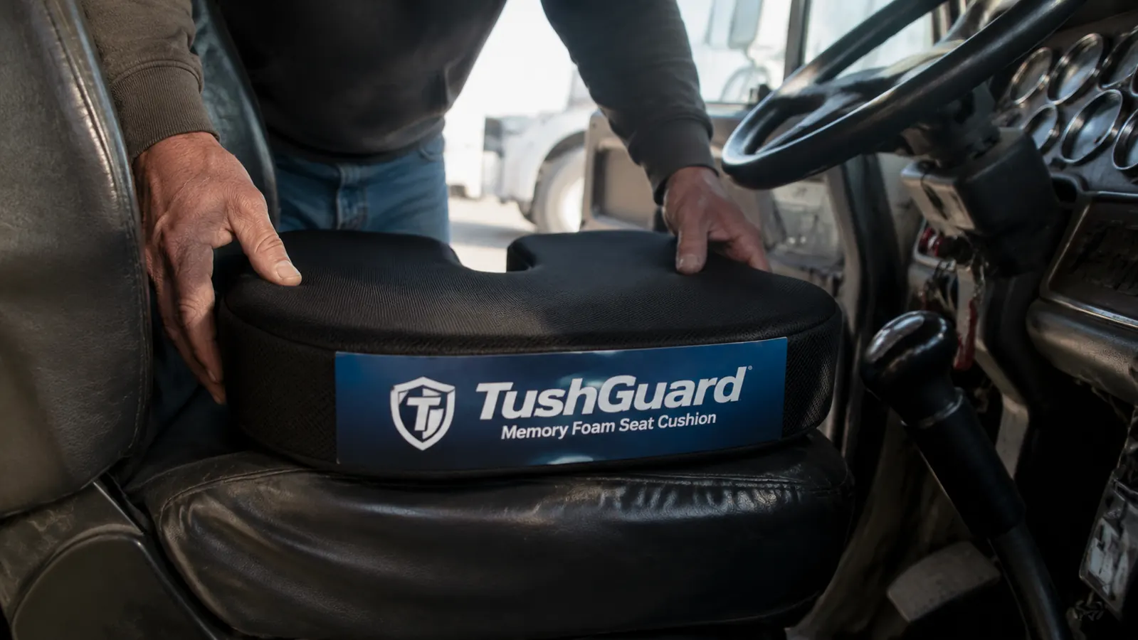 Memory foam seat cushion placed on a truck driver seat inside a semi cab