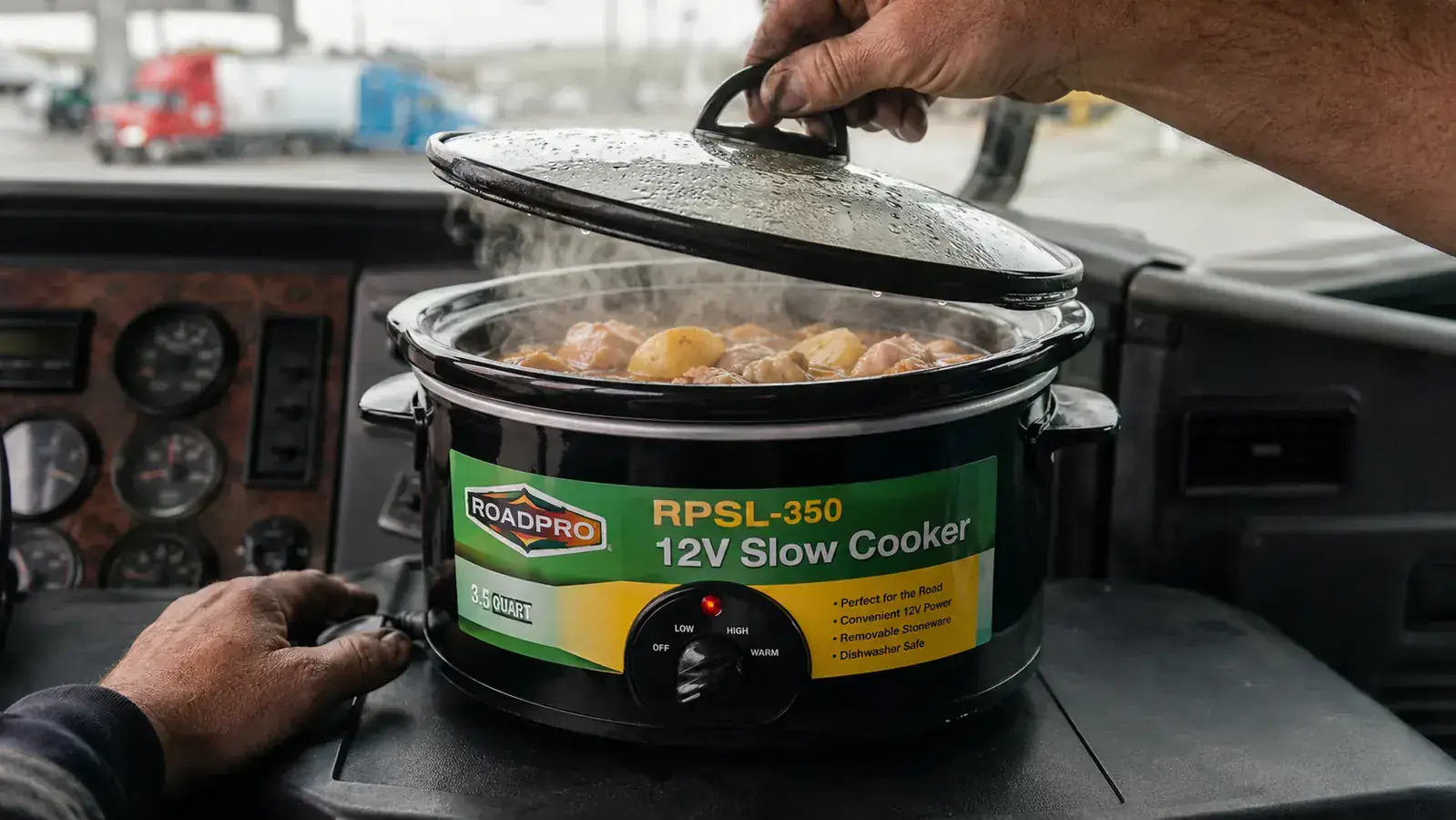 Hand lifting the lid off the RoadPro slow cooker to check on a chicken and potato stew inside