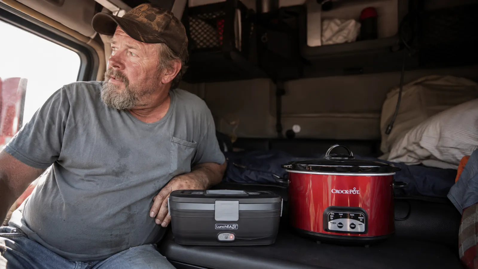 HotLogic Mini lunch box style container on a truck seat compared to RoadPro slow cooker size