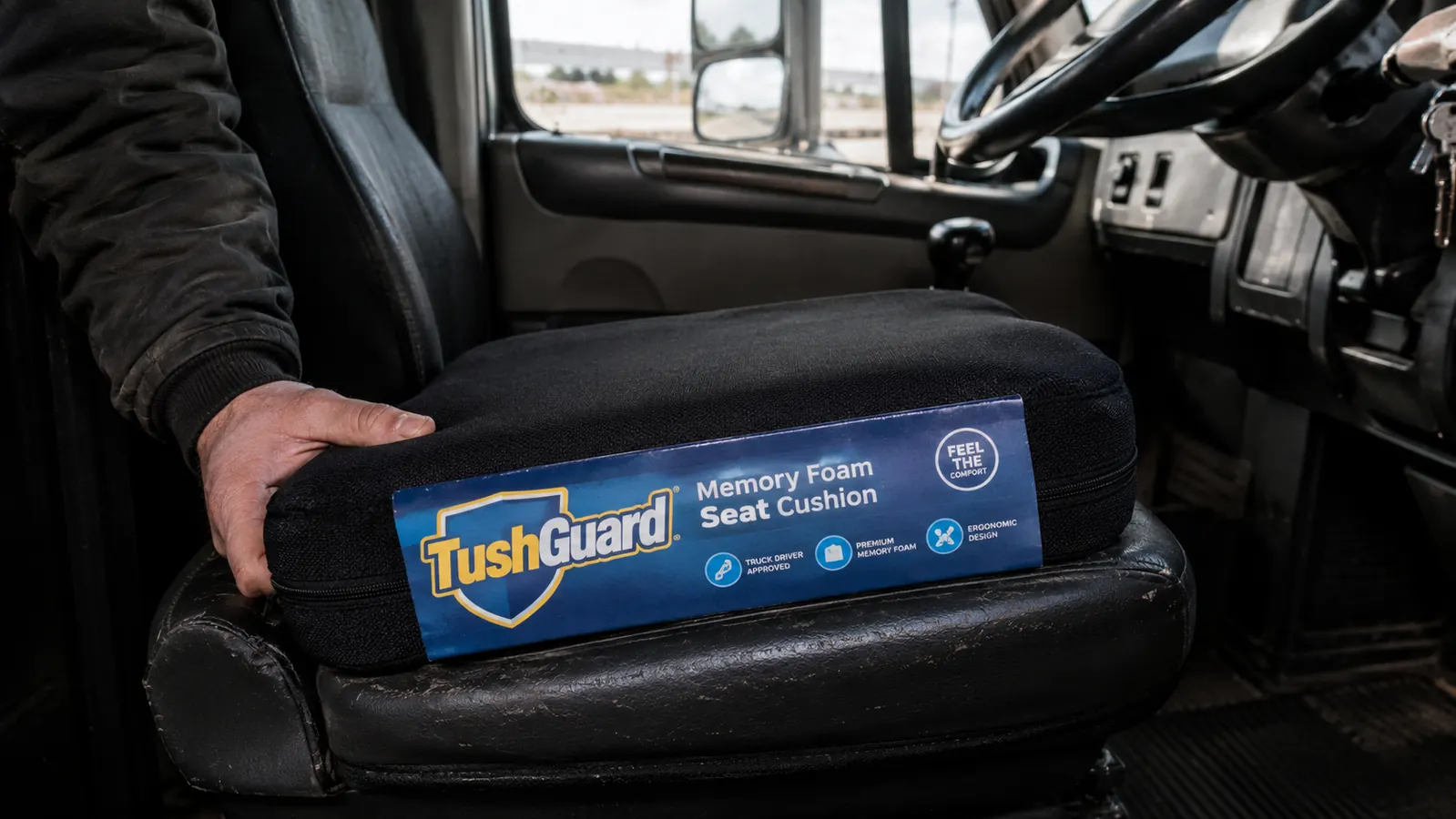 TushGuard memory foam seat cushion placed on a vinyl truck seat inside a semi cab
