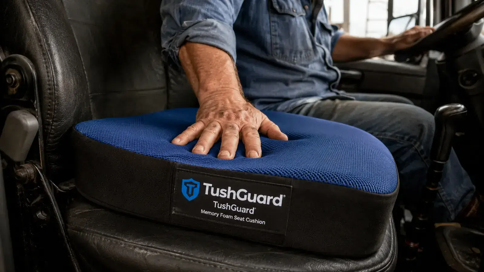 TushGuard memory foam cushion on a Kenworth truck seat, driver adjusting position before a long haul