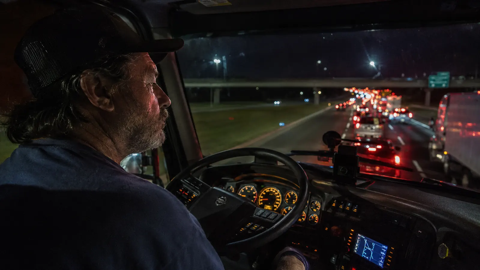 Traffic backed up on Interstate 40 in Tennessee at night, semi trucks lined bumper to bumper for miles